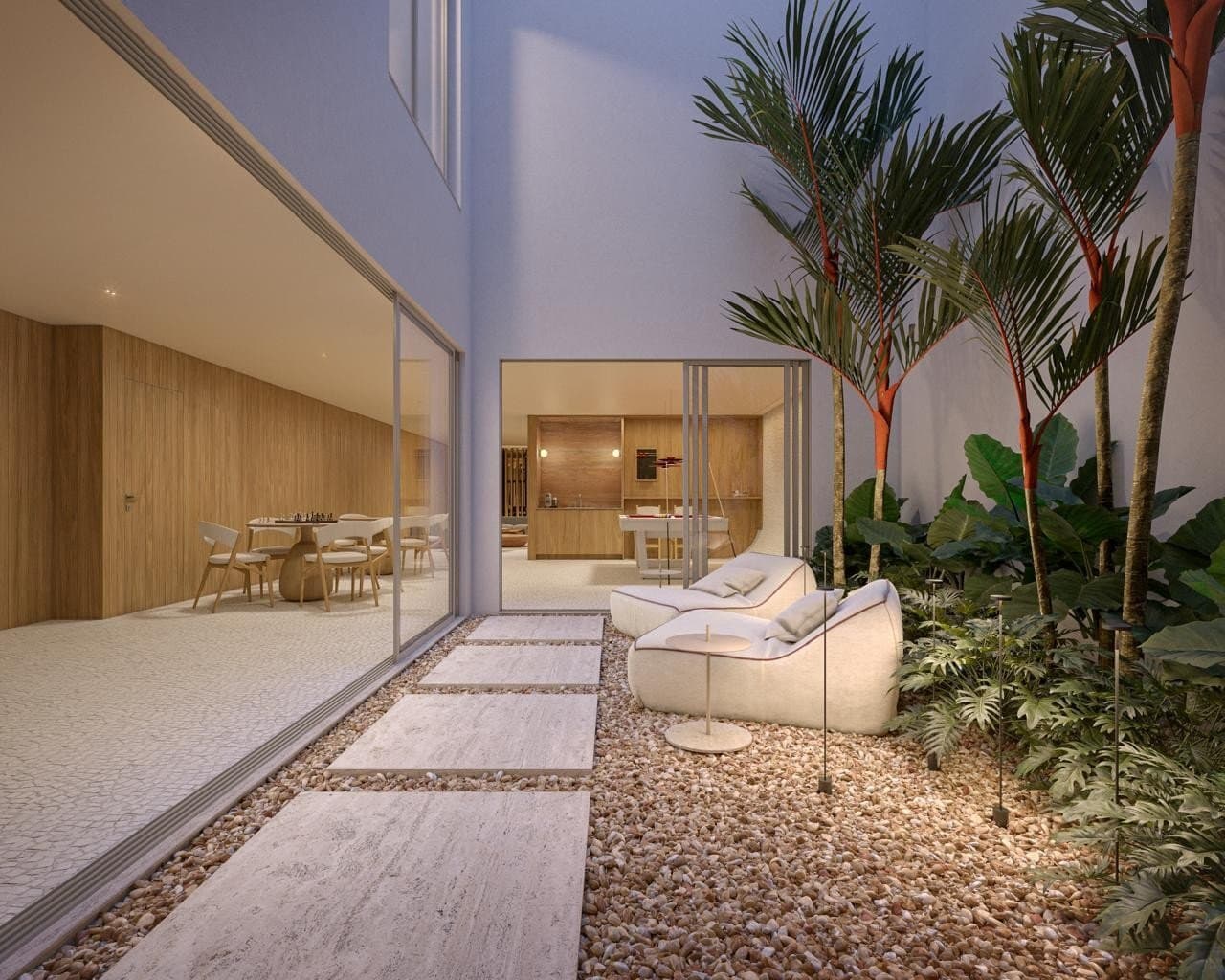 Unidade Up Garden do Garcya Praia Studios com jardim privativo, piso em pedras naturais, poltronas externas, palmeiras tropicais e integração com sala de jantar e cozinha.